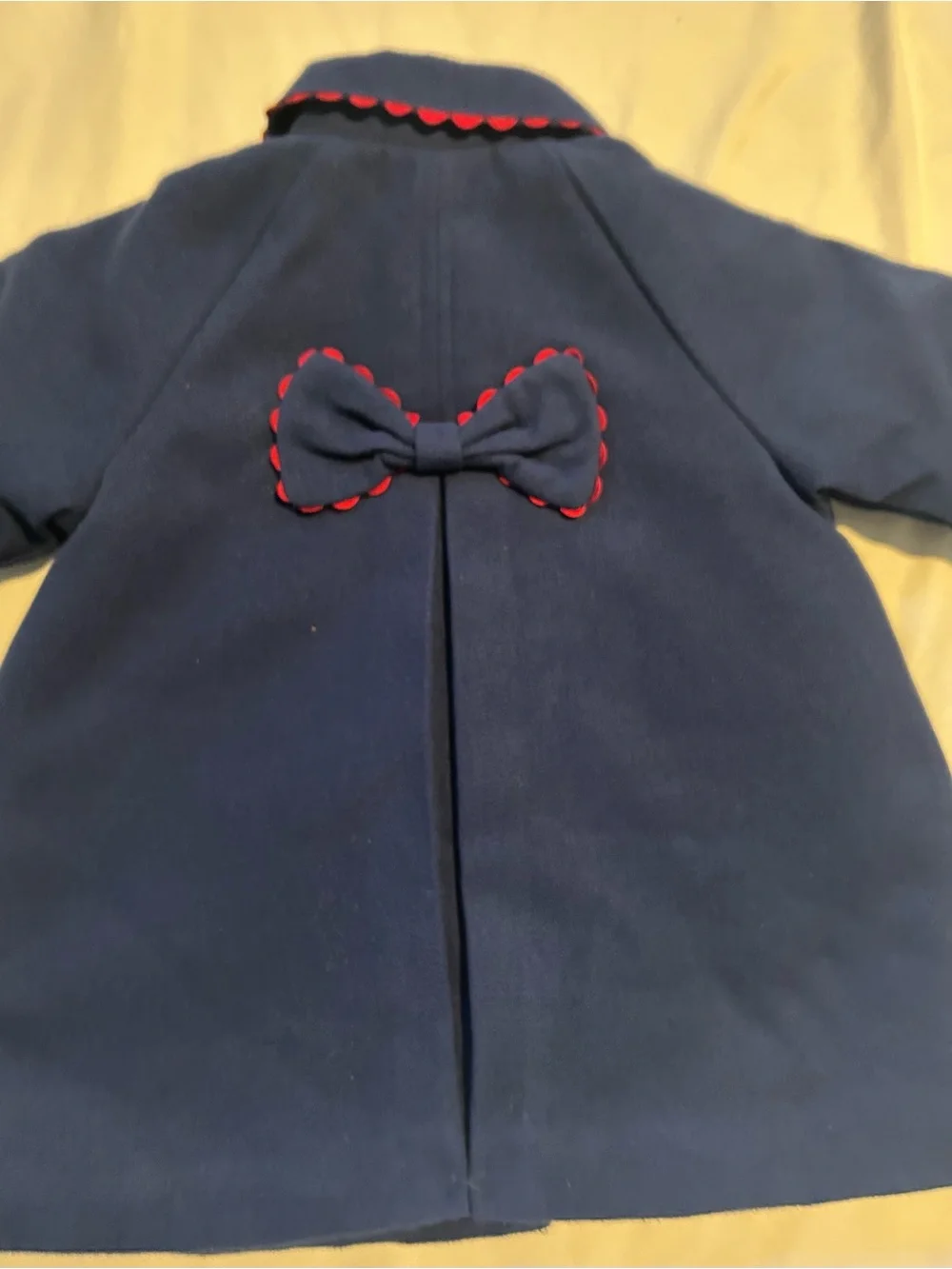 Little Me Navy Pea Coat with Red Scallop Trim and Bow.